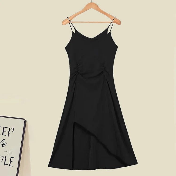 Black asymmetrical slip dress with spaghetti straps, knee-length, and side ruching detail.  Part of a chic knit sweater and dress set.