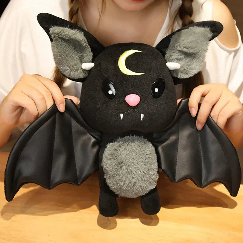 Kawaii black bat plush toy with crescent moon, faux leather wings, and soft PP cotton filling.  Halloween décor, gift.