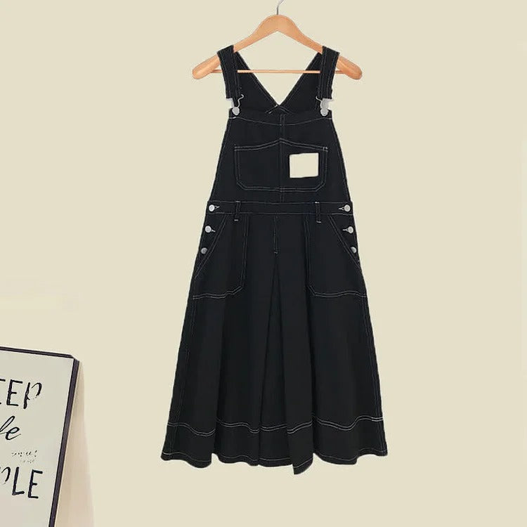 Black denim overall dress with long sleeves and white stitching detail.  Features a preppy style and long length.