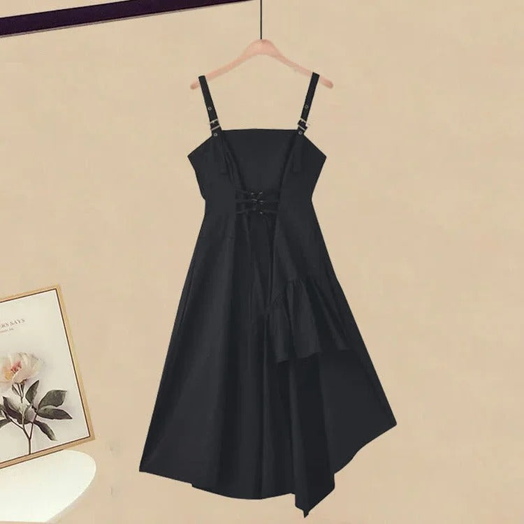 Black polyester midi dress with asymmetrical hem, lace-up back, paired with a black oversized cable knit turtleneck sweater.
