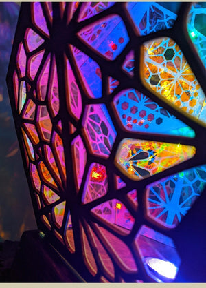 Color-changing bohemian projector lamp; intricate wood & plastic design, casts vibrant patterns. USB powered.