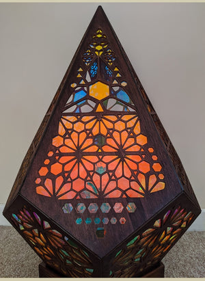Geometric bohemian wood projector lamp with color-changing LED lights, casting intricate patterns. USB powered.