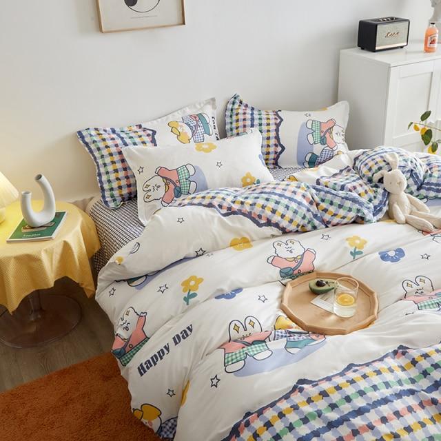 Cute bunny microfiber bedding set; white background with colorful bunnies, flowers & stars. Reversible design, includes duvet cover, flat sheet & pillowcases.