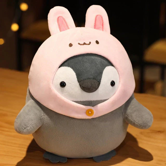 Adorable grey penguin plush toy wearing a pink bunny hood, made of soft PP cotton, hypoallergenic, available in various sizes.