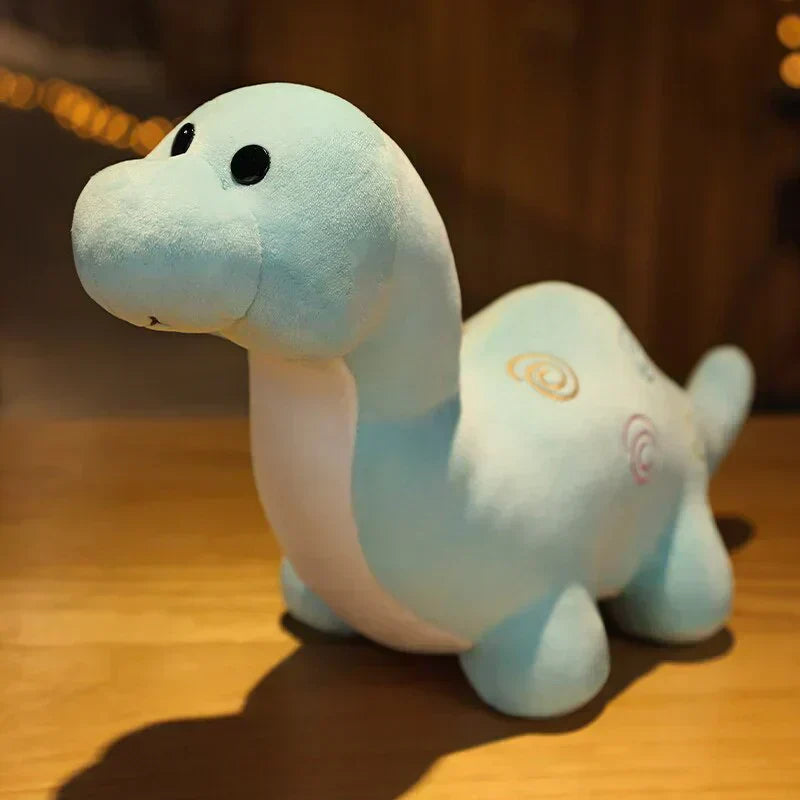 Cute light-blue chibi dinosaur plush toy, made of soft PP cotton, featuring swirling pastel designs.
