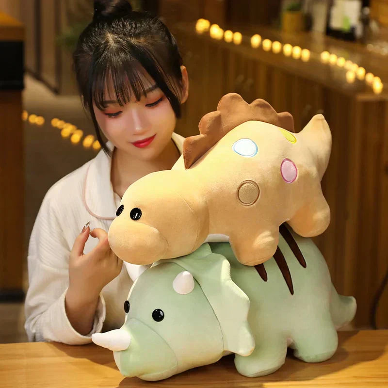 Adorable chibi dinosaur plush toys; tan stegosaurus & green triceratops. Soft PP cotton, 3 sizes (6", 10", 14"). Perfect gift!