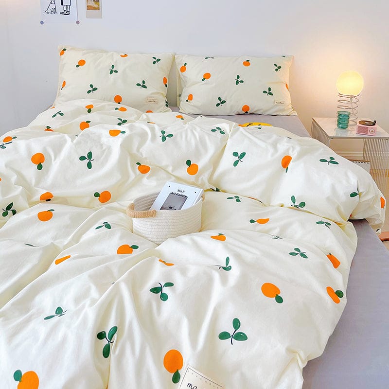 Cream cotton bedding set with cute orange and green leaf pattern. Includes duvet cover, flat sheet, and pillowcases.  Available in Twin, Full, & Queen.