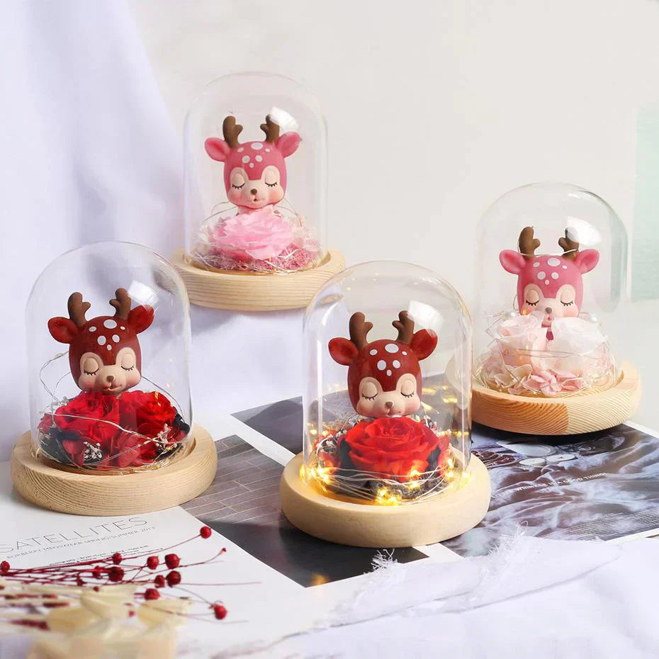 Glass dome LED display with preserved rose & cute deer figurine; warm light. Perfect gift.