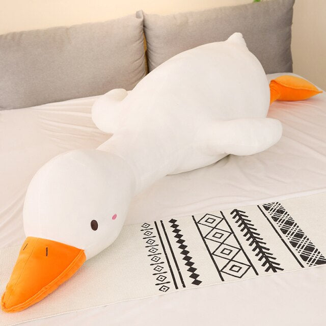 Giant Flora swan plush pillow, white with orange beak, made of premium PP cotton.  Hypoallergenic, perfect for snuggling.