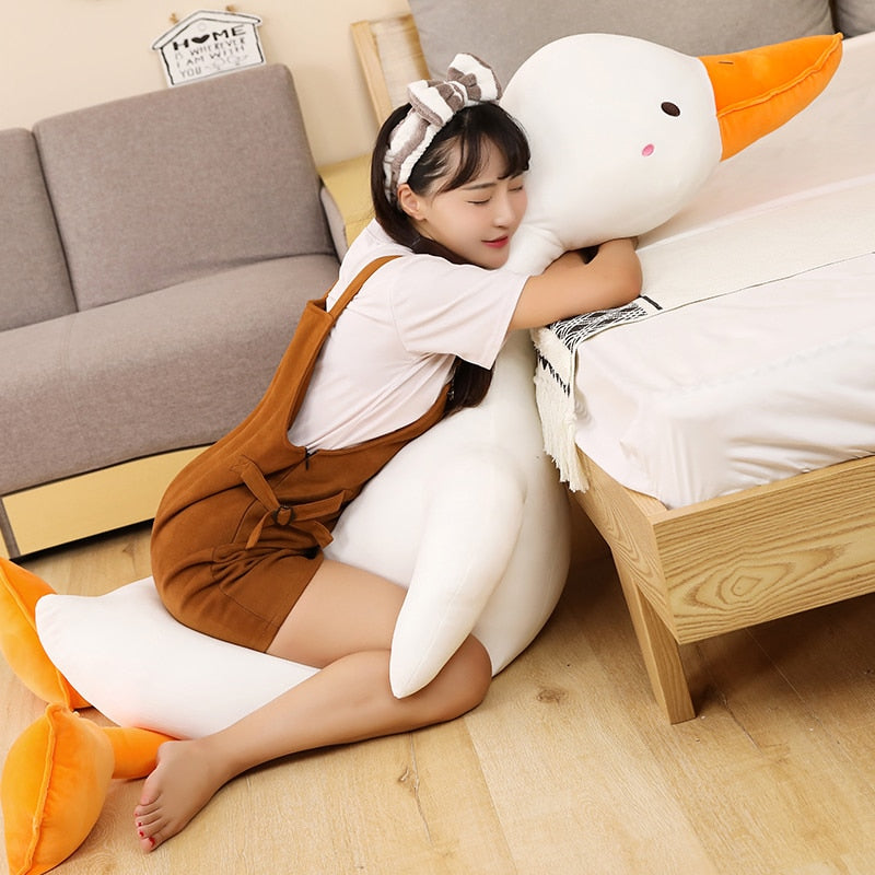 Giant Flora swan plush pillow; white with orange beak, soft PP cotton filling, hypoallergenic, for relaxation and snuggling.