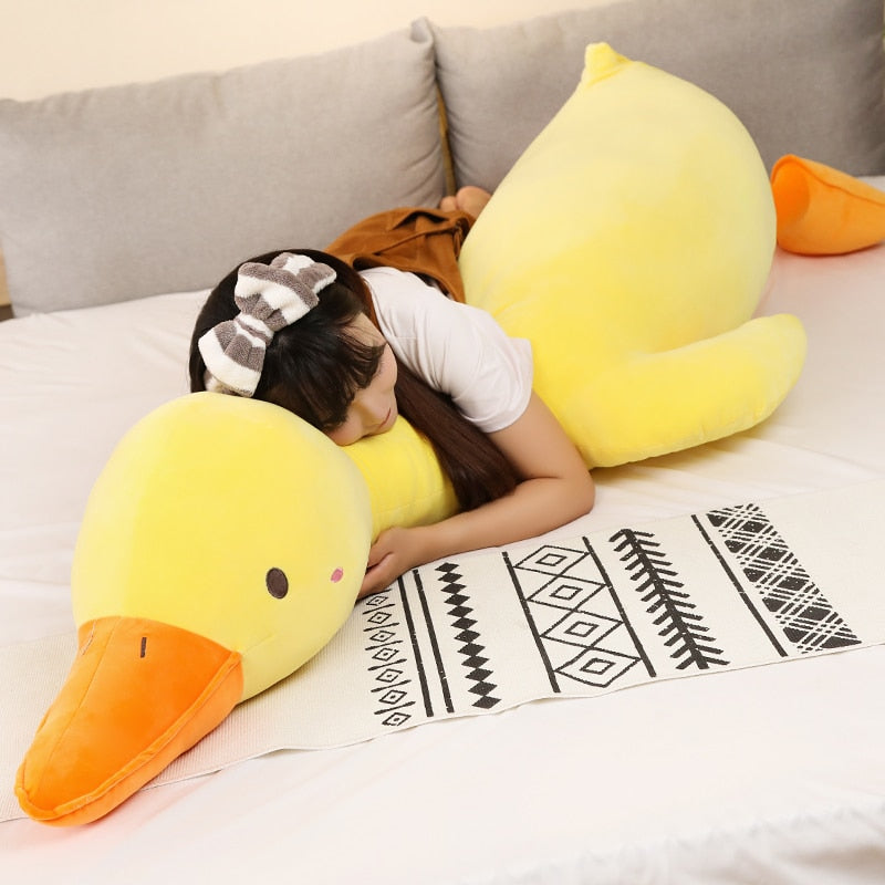 Giant yellow Flora swan plush pillow, super-soft PP cotton filling, promotes relaxation.  Hypoallergenic & ethically sourced.