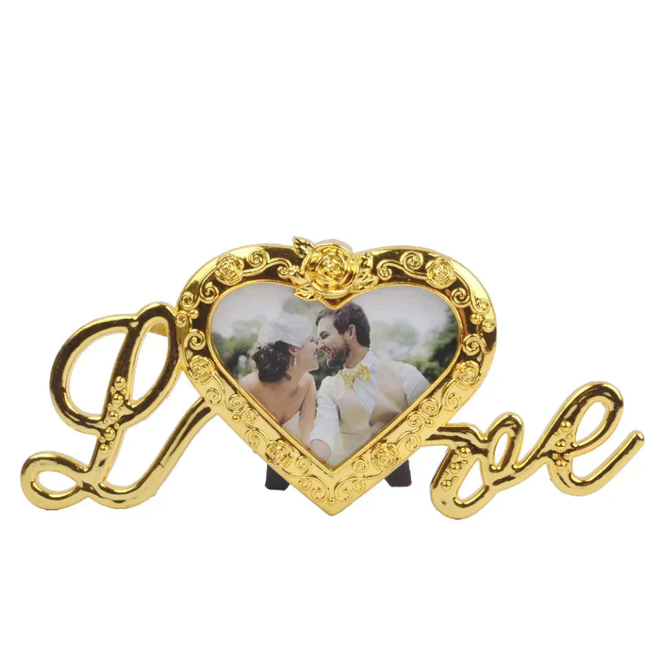 Gold-plated heart picture frame with "Love" inscription, featuring a rose accent and a stand. Holds a photo. Perfect gift.
