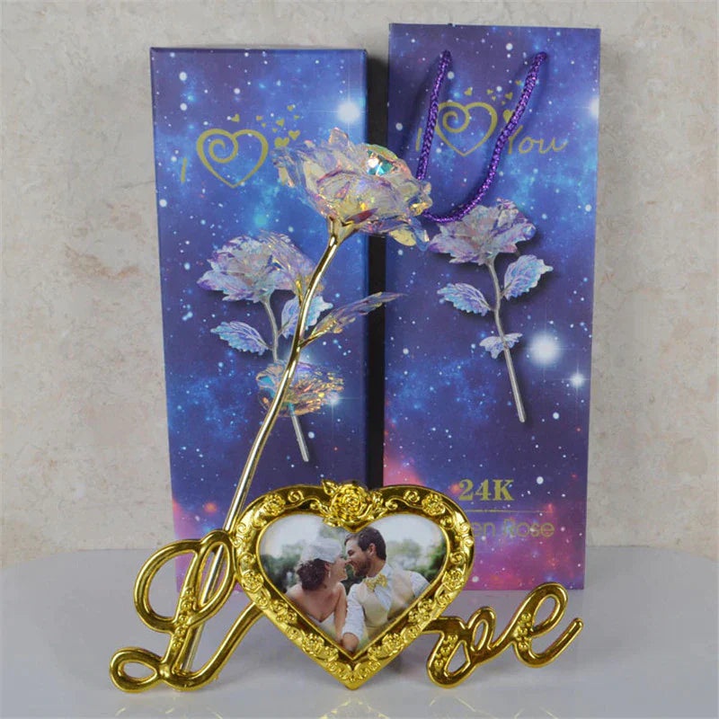 24k gold-plated heart frame with iridescent galaxy rose, "Love" lettering, & photo insert. Perfect gift.