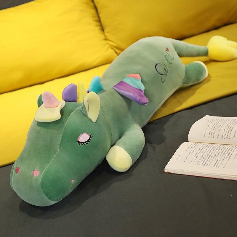 Green plush unicorn body pillow with rainbow wings, soft PP cotton filling, and embroidered "Sweet" detail.  Perfect for snuggling!