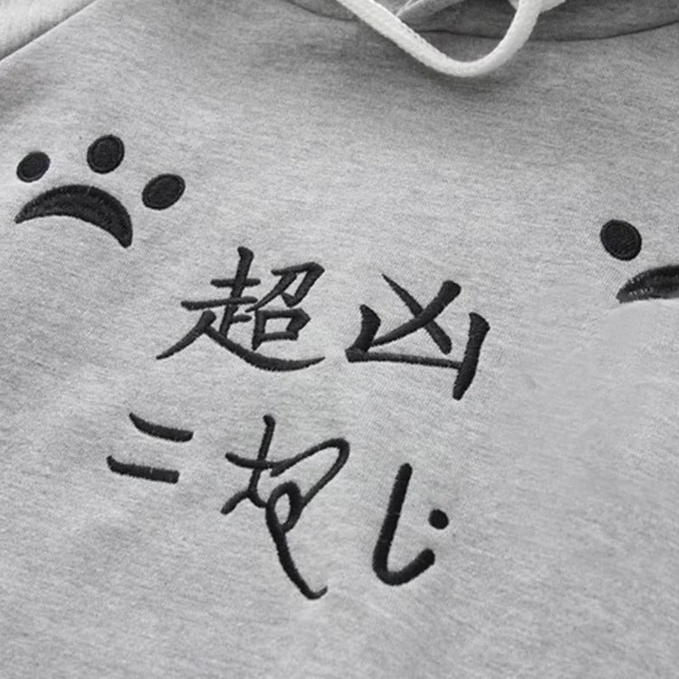 Grey Harajuku cat paw print hoodie with embroidered Japanese characters, plush polyester, cat ears on hood.