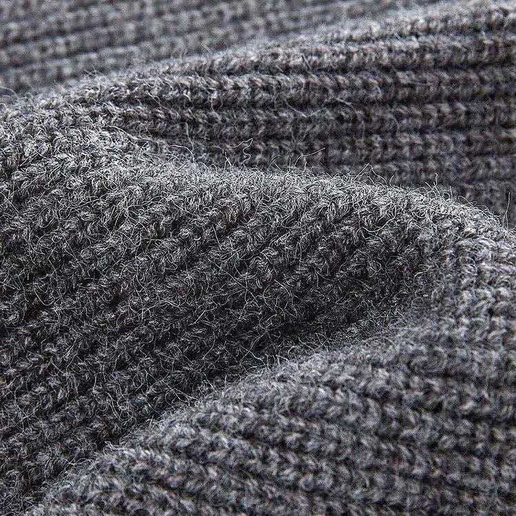 Grey knit sweater detail; cozy, long-sleeved, polyester fabric.  Part of a chic sweater & slip dress set.