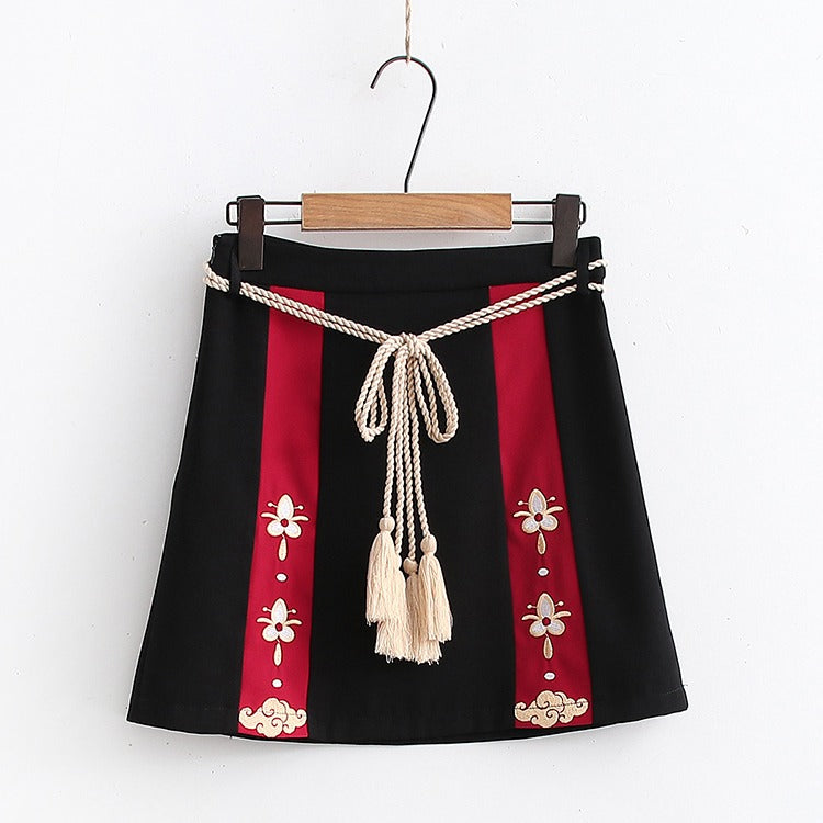 Red & black Harajuku mini skirt with lucky cat embroidery, cream rope belt, and tassel.  Cotton blend.