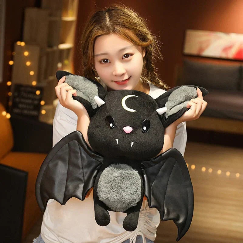 Adorable black kawaii bat plush toy with crescent moon, faux leather wings, and soft PP cotton filling.