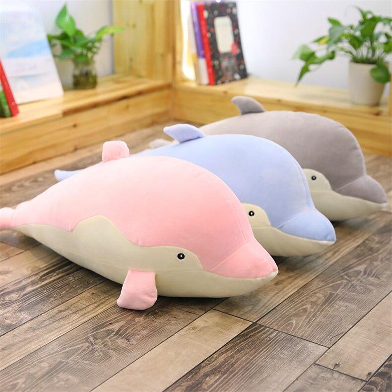 Kawaii plush dolphin body pillow in pink, blue, and gray; soft PP cotton filling; promotes relaxation and better sleep.
