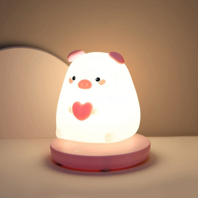 Kawaii pig silicone night light, warm white LED, 3 brightness settings, USB rechargeable, 10hr battery life.