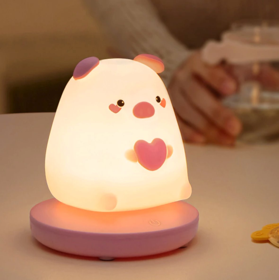 Kawaii pig silicone night light with warm white LED, 3 brightness settings, USB rechargeable, 10-hour battery life.