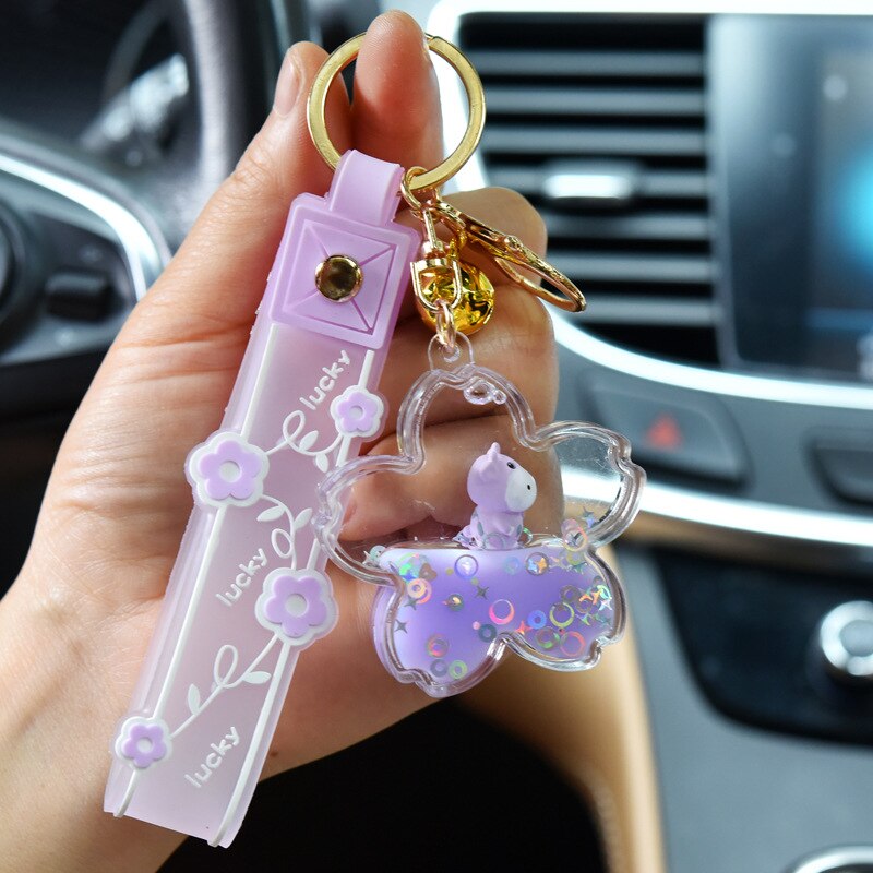 Lavender Sakura Cow quicksand keychain with gold accents, featuring a cute cow charm in a flower-shaped resin case.