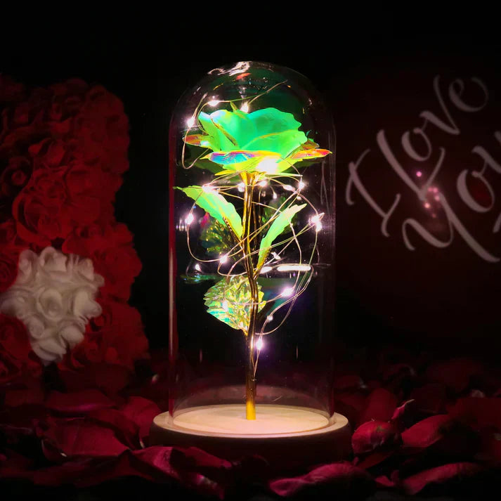 Iridescent LED rose in glass dome with warm white lights, wooden base; perfect gift.