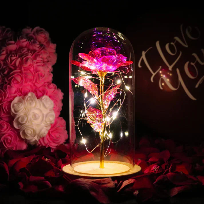 Iridescent LED rose in glass dome with warm lights, wooden base; perfect gift for anniversaries or birthdays.