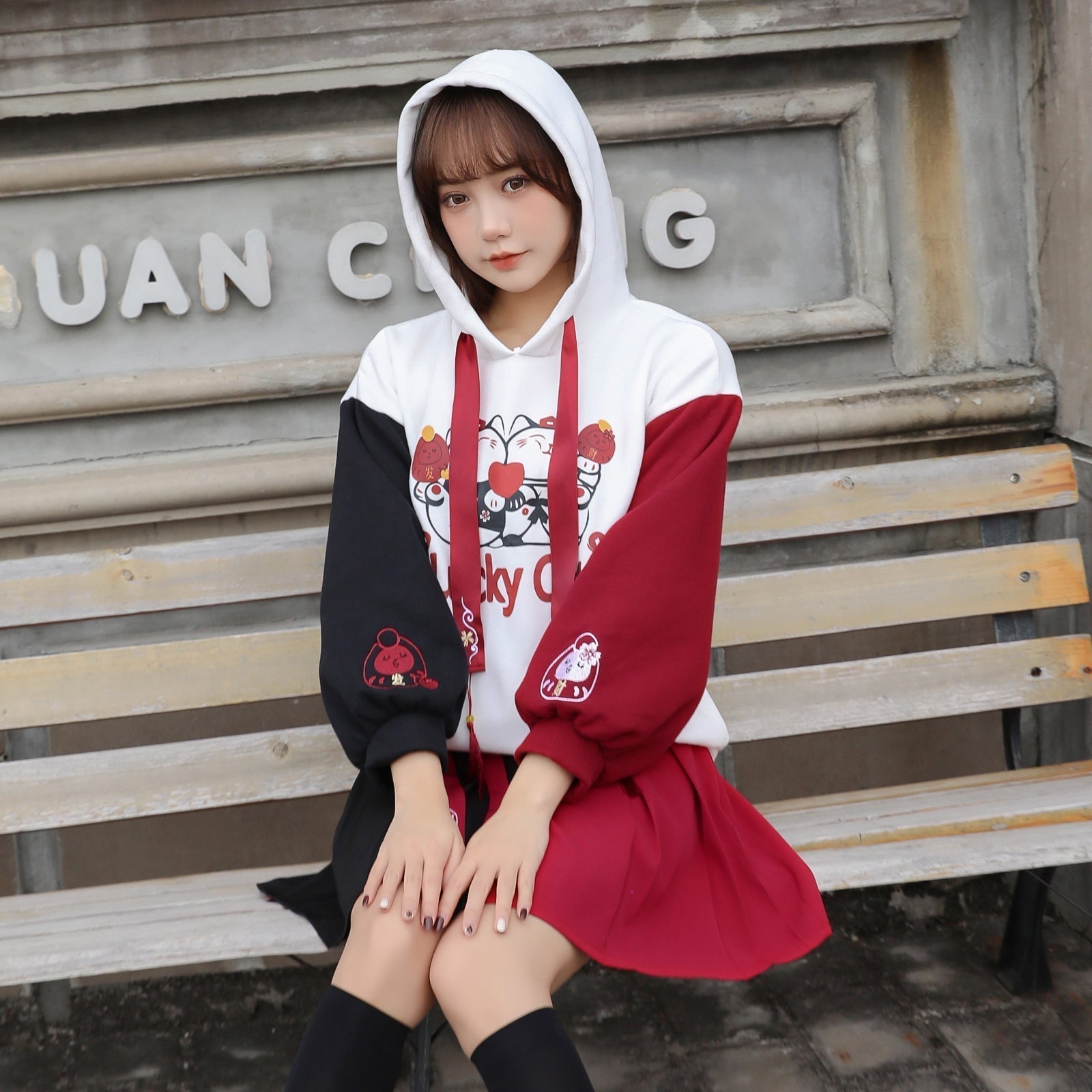 Red & black colorblock lucky cat hoodie & skirt set; features cartoon cat print, tassels, and cat paw details.  Cute, comfy cotton.