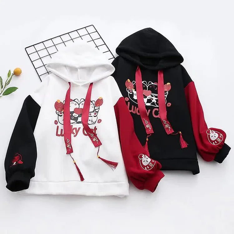 Cute lucky cat hoodie & skirt set; white/black colorblock, red tassels, cartoon print. Cotton, comfy.