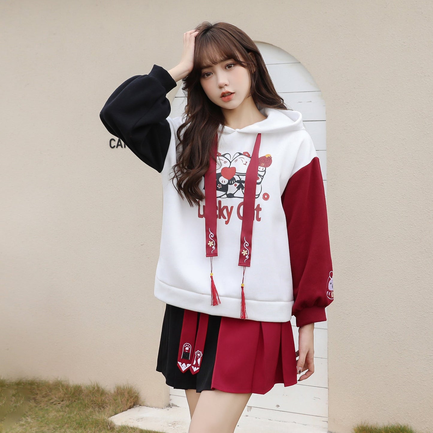 Red & white lucky cat hoodie and pleated skirt set; cotton, cartoon print, tassel details.