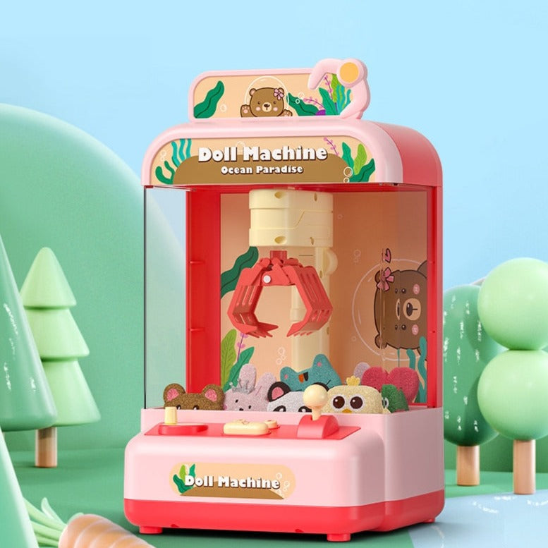 Pink mini claw machine arcade game with ocean theme, includes plush toys, light & sound effects. Measures 18x15x29cm.