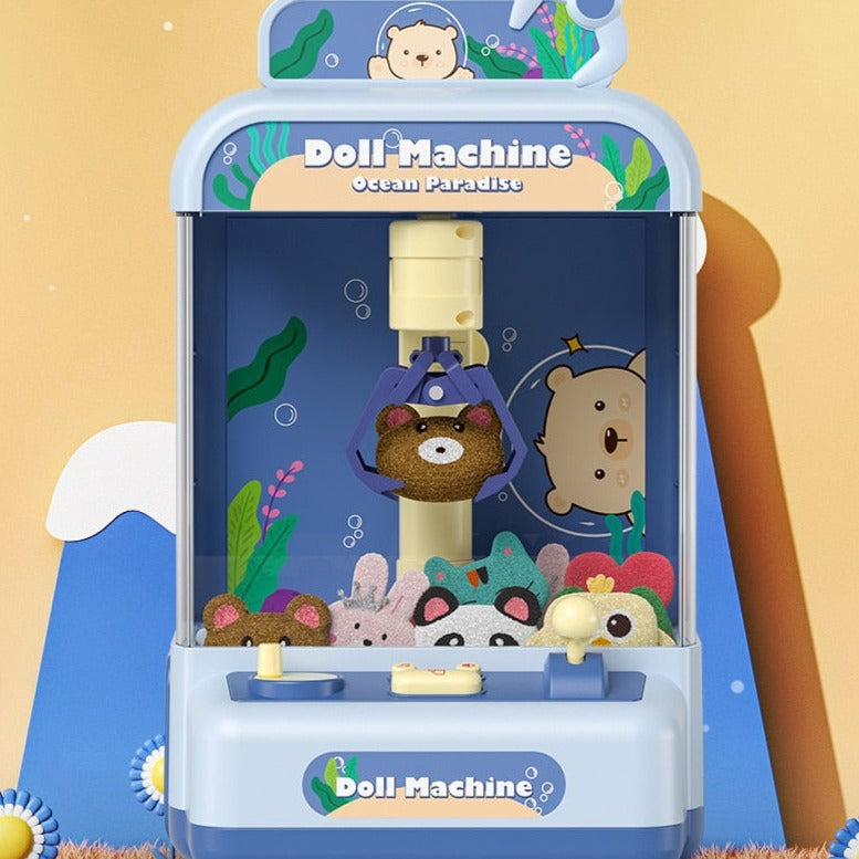 Blue mini claw machine arcade toy with ocean theme, featuring plush prizes and light/sound effects.  18x15x29cm.