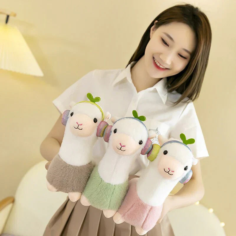 Adorable musical alpaca plush toy with soft cotton, pastel colors, and headphone design. Ethically sourced and perfect for cuddling.