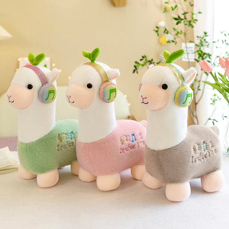 Adorable musical alpaca plush toy in green, pink, and grey; super-soft cotton, ethically sourced.