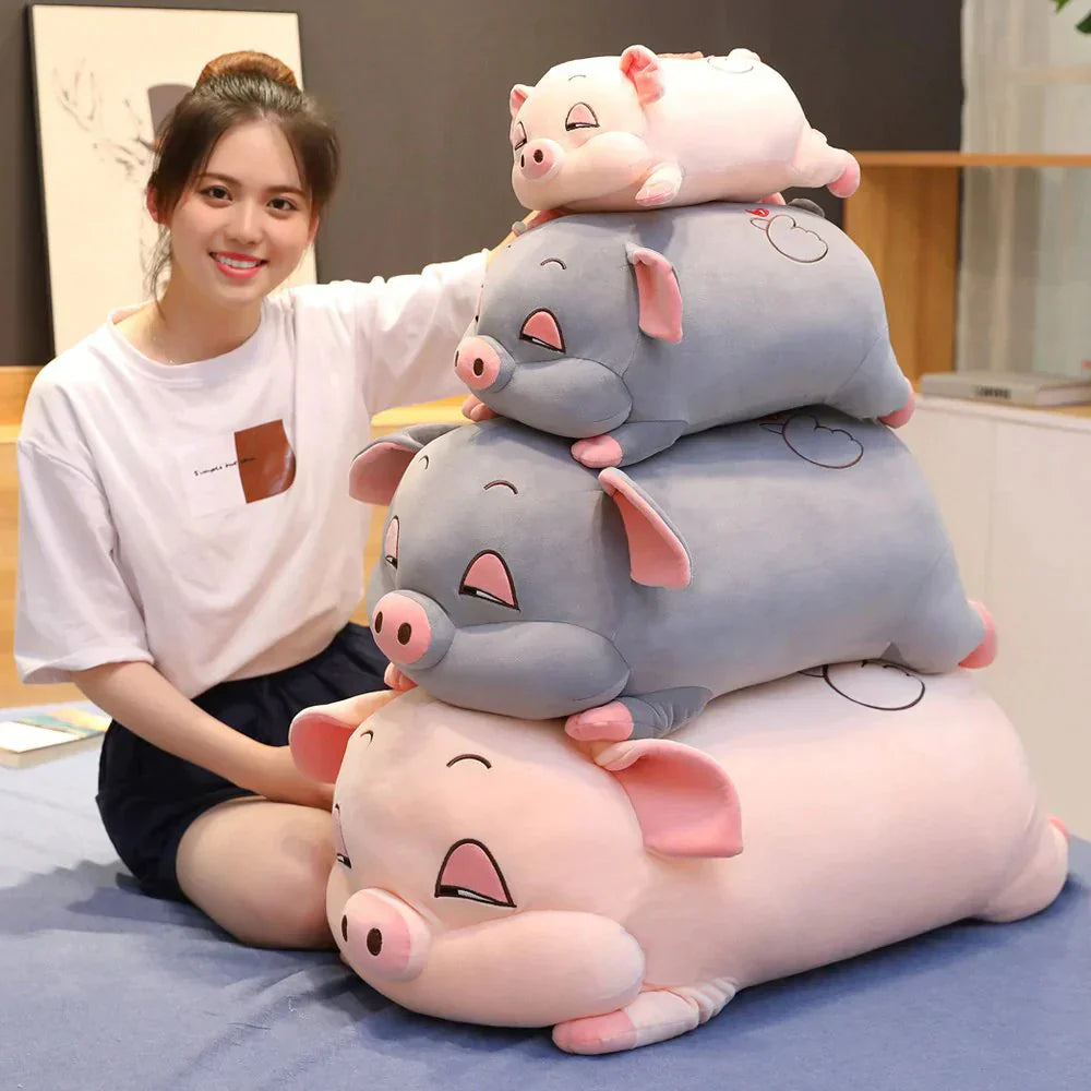 Stack of three adorable pig plushies; pink, grey, and white; made with soft, hypoallergenic cotton; perfect for cuddling and sleeping.