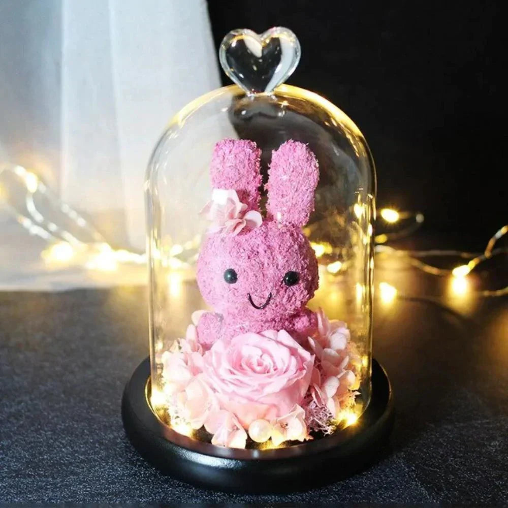 Pink bunny and preserved rose LED display in glass dome; 12x20cm, battery-operated. Perfect gift.