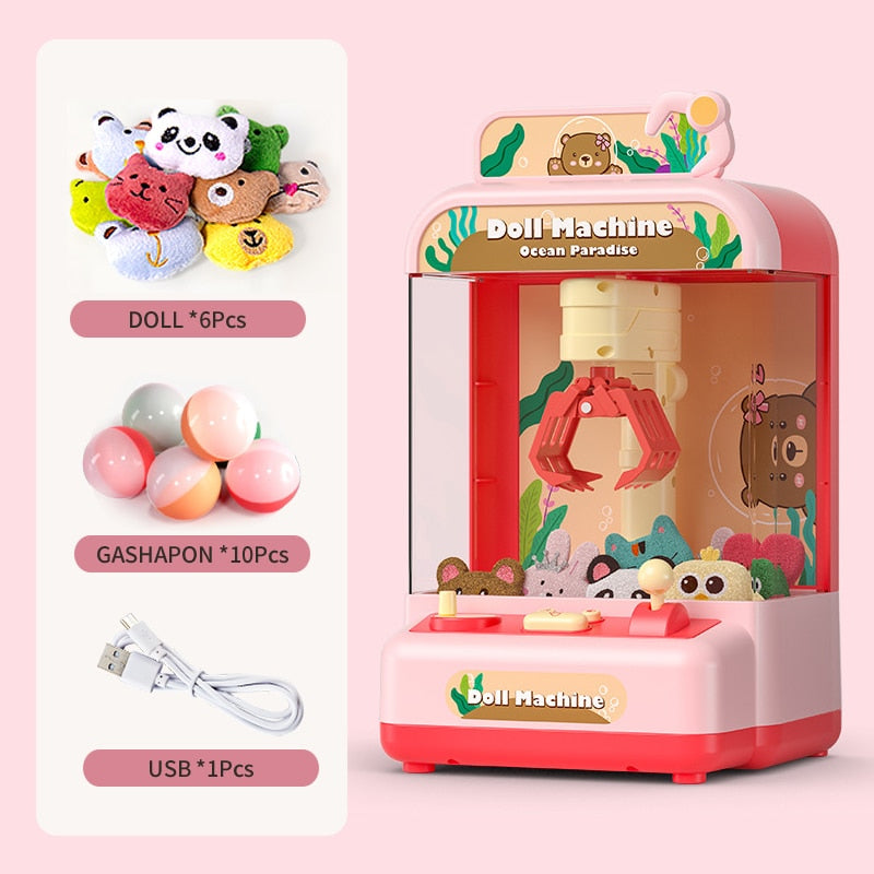 Pink mini claw machine arcade game with ocean theme, includes 6 plush toys & 10 gashapon balls, USB powered.
