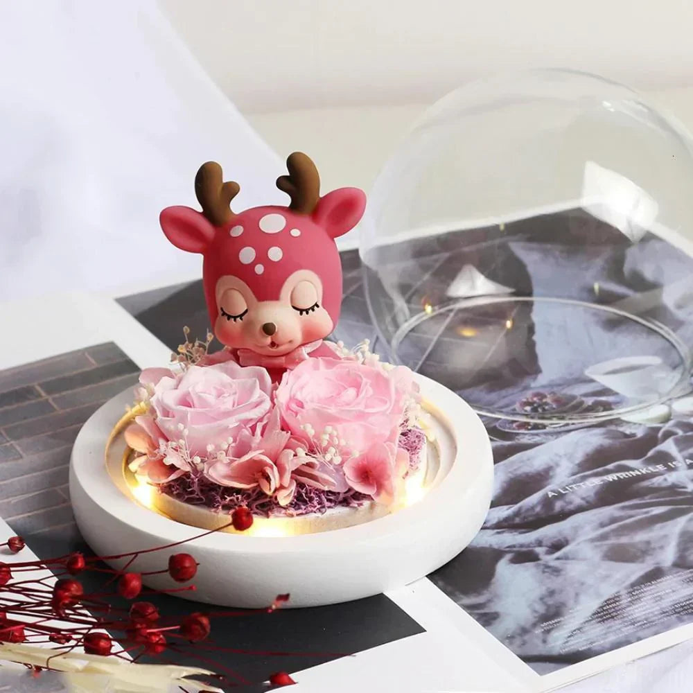 LED display featuring a preserved pink rose & adorable red deer figurine under a glass dome. Perfect gift!