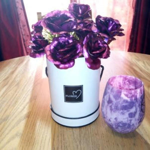 12 iridescent purple galaxy roses in a white gift box with a matching purple candle; perfect gift for any occasion.
