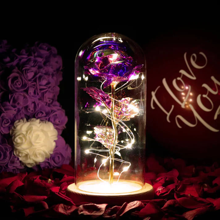 Iridescent purple rose with gold stem, encased in glass dome with LED fairy lights; perfect gift for Valentine's Day, birthdays, or anniversaries.