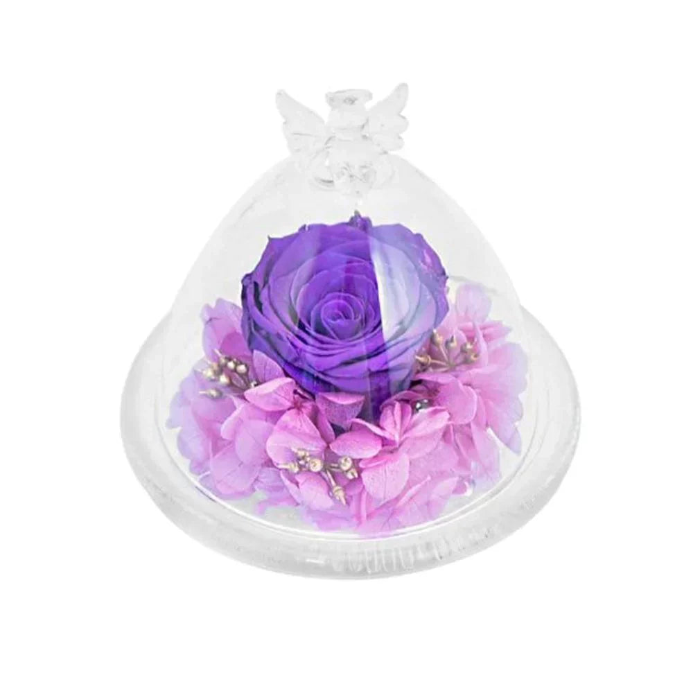 Preserved purple rose in glass dome with angel wings, nestled on pink hydrangeas.  Wooden base, 10x10x16cm or 12x12x12cm.
