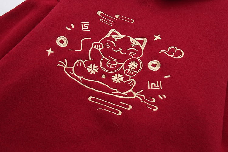 Red Harajuku lucky cat hoodie and mini skirt set. Features gold embroidery, cotton blend fabric, and drawstring hoodie.