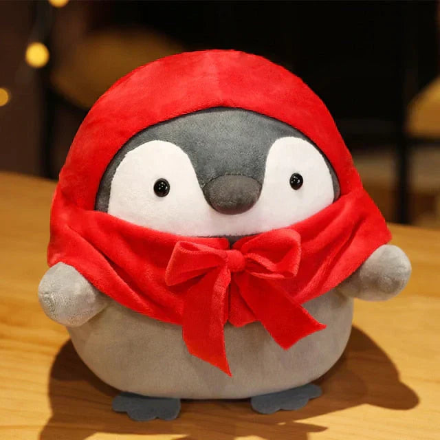 Adorable chubby penguin plush toy wearing a red hooded cape, made of soft PP cotton, hypoallergenic, and available in various sizes.