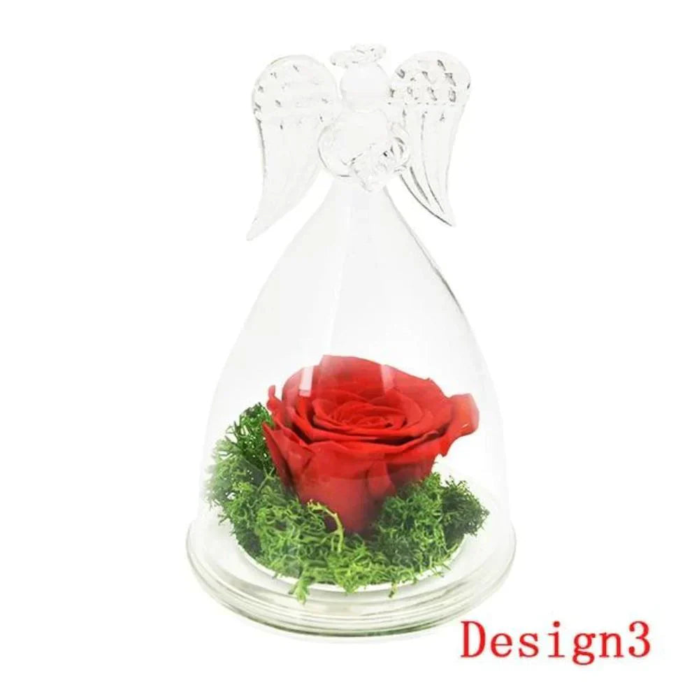 Red preserved rose in glass dome with angel wings, nestled on moss.  Elegant, long-lasting décor.
