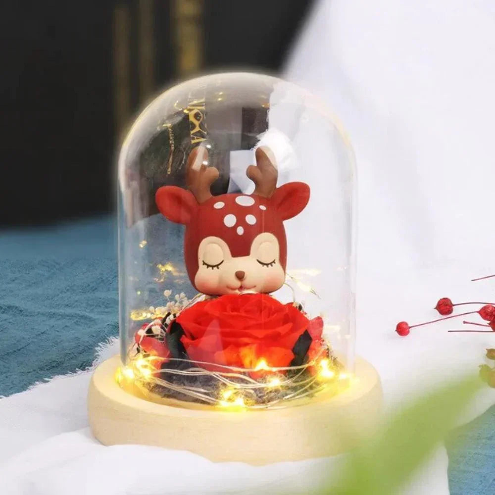 Glass dome LED display featuring a preserved red rose and adorable deer figurine; warm LED lights; perfect gift.