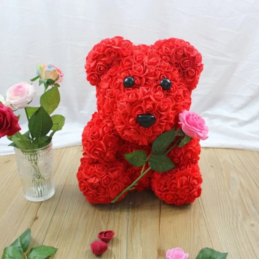 Red rose teddy bear gift, handcrafted plush bear adorned with artificial roses, romantic keepsake.