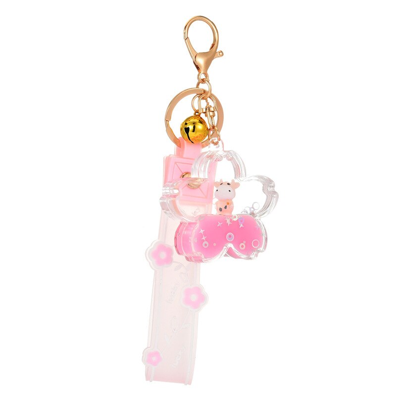 Pink Sakura cow quicksand keychain with gold bell, resin and zinc alloy. Cute design, mesmerizing glitter.