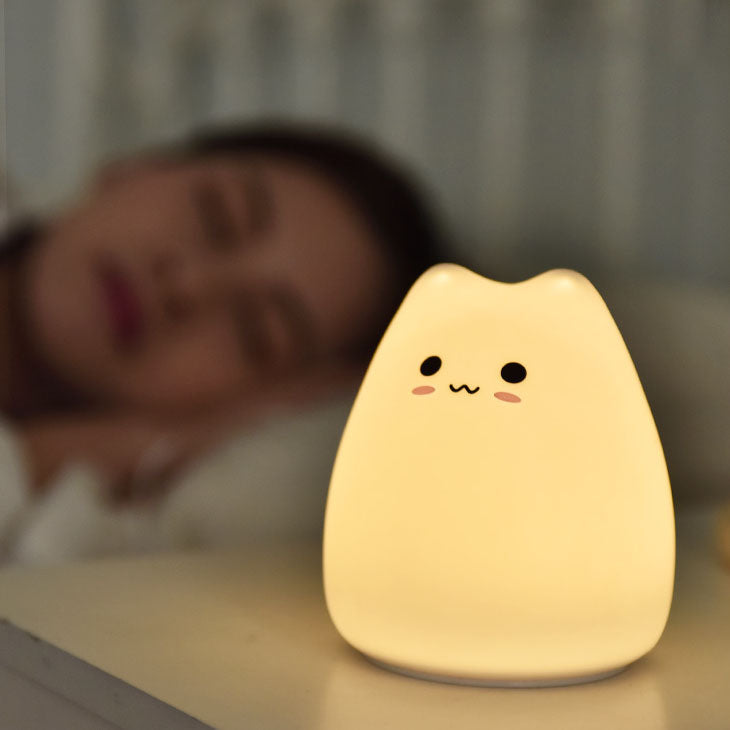 Cute white silicone cat night light, color-changing LED, soft glow, perfect for bedrooms.