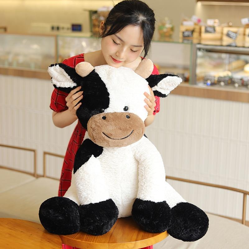 Super-soft, huggable spotty cow plush toy; white with black spots, made with premium PP cotton filling.  Perfect gift!